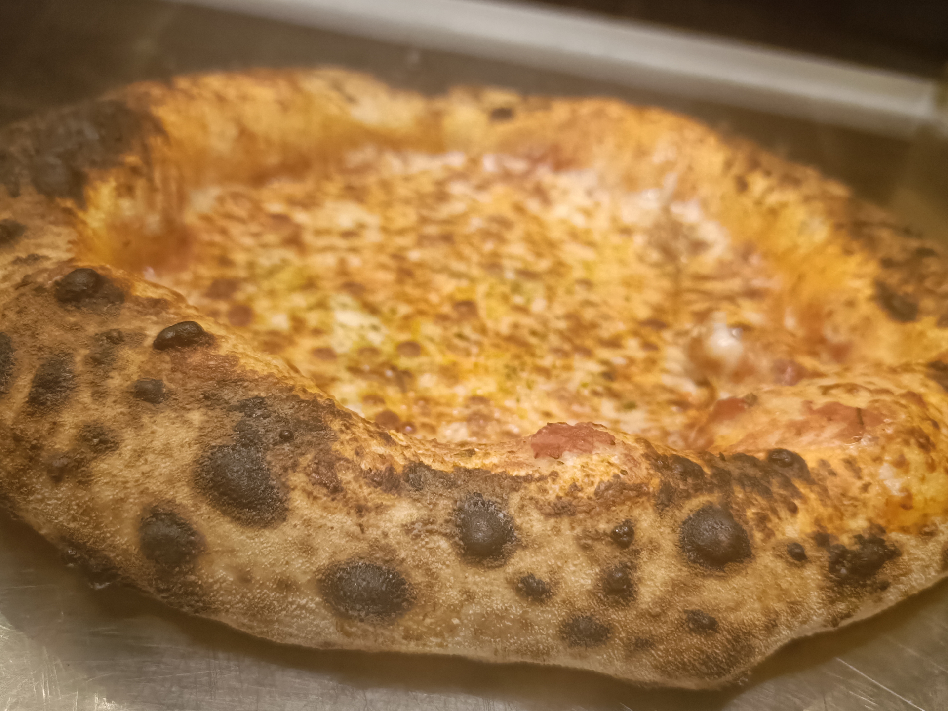 Wood-fired pizza with leopard crust